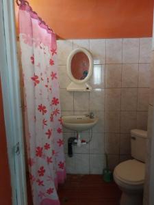 a small bathroom with a sink and a toilet at Casa Ibañez in Talara