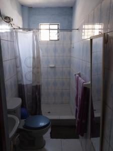 a bathroom with a toilet and a shower and a sink at Casa Ibañez in Talara