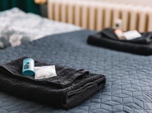 a black bed with a black towel on it at Apartmán Mlynská in Vranov nad Topľou