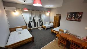 a room with two beds and a table and chairs at KEISA APARTRooms in Nowy Sącz +35 photos