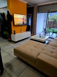a living room with a couch and a table at The Blyde Luxury Apartments in Pretoria