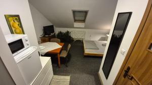 a small room with a kitchen and a dining room at KEISA APARTRooms in Nowy Sącz