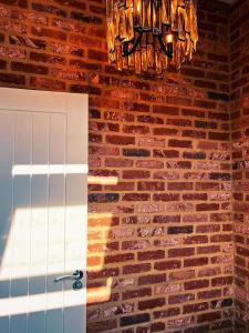 a brick wall with a door and a chandelier at Penthouse 333a in Middlesbrough +55 photos