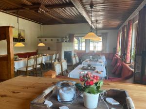 a dining room with a table and a living room at Hotel Domblick in Bad Honnef am Rhein +25 photos