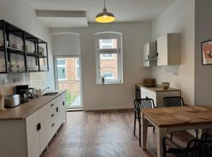 a kitchen with a table and a dining room at Appartement "Peter" in Köthen mit 3 Schlafzimmern in Köthen +2 photos