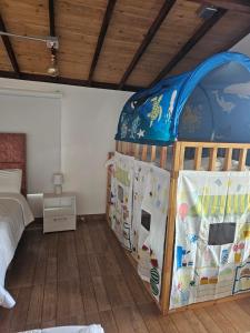 a bedroom with a bed and a crib at Manawa Kaona in Somondoco +2 photos