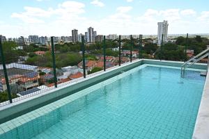 a swimming pool with a view of a city at Nobile Stays Ininga in Teresina +16 photos