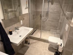 a bathroom with a shower and a sink and a toilet at Centrally located in Coesfeld in Coesfeld