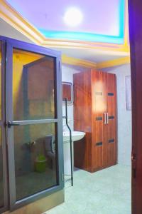 a bathroom with a sink and a cabinet in a room at Brazza Hôtel in Brazzaville