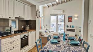 a kitchen with a table with blue dishes on it at Luxury House in Cefalù