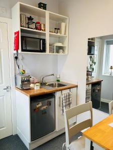 a small kitchen with a sink and a counter at Your Harrogate Stay in Harrogate