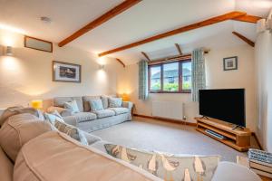 a living room with a couch and a flat screen tv at 3 Bed in St. Merryn oc-m29320 in Saint Merryn