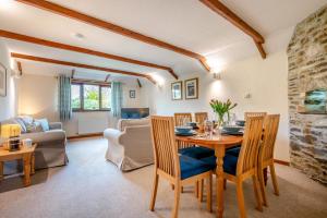 a dining room and living room with a table and chairs at 3 Bed in St. Merryn oc-m29320 in Saint Merryn