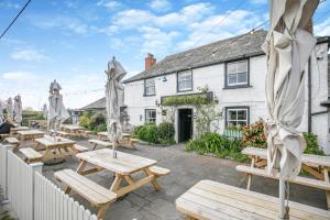 a group of picnic tables in front of a building at 3 Bed in St. Merryn oc-m29320 in Saint Merryn