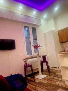 a living room with a table and two chairs and a window at Mini white apartment in Scandicci +3 photos