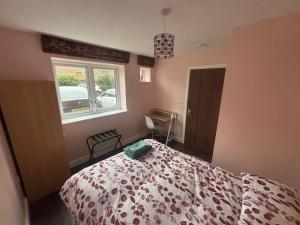 a bedroom with a bed and a window at Hawksbill way in Peterborough