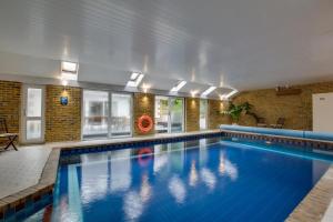 a large swimming pool with a person in the water at 4 Bed in Ovingdean oc-bbvale in Rottingdean