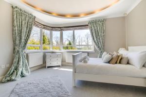 a bedroom with a white bed and a window at 4 Bed in Ovingdean oc-bbvale in Rottingdean +22 photos