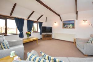 a living room with couches and a flat screen tv at 2 Bed in Padstow oc-w3658 in Saint Merryn