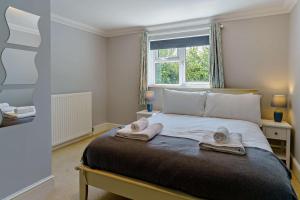 a bedroom with a bed with two towels on it at 3 Bed in Mumbles oc-b27725 in The Mumbles