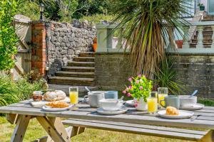a picnic table with food and drinks on it at 3 Bed in Mumbles oc-b27725 in The Mumbles