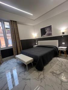 a bedroom with a king sized bed with a marble floor at Hotel Garda in Rome