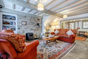 a living room with two couches and a stone wall at 4 Bed in Alcester oc-s30997 in Alcester