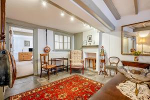 a living room with a table and chairs and a mirror at 4 Bed in Alcester oc-s30997 in Alcester