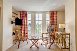 a living room with chairs and a table and a television at 2 Bed in Brecon oc-t32728 in Brecon