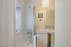 a white bathroom with a shower and a sink at 2 Bed in Brecon oc-t32728 in Brecon +29 photos