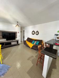 a living room with a couch and a television at CASA in Piranhas