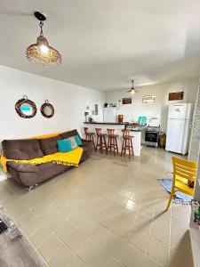 a living room with a couch and a kitchen at CASA in Piranhas