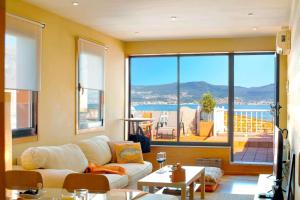 a living room with a couch and a large window at El Atico de Vigo in Vigo
