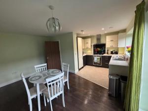 a kitchen and dining room with a table and chairs at Hawksbill way in Peterborough