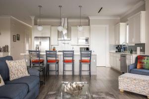 a kitchen and living room with a couch and a table at Seagate House -Waterfront w Dock in Key West +25 photos