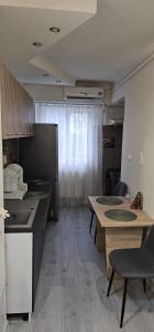 a kitchen with a table and chairs in a room at Apartament Daniela in Râmnicu Vâlcea