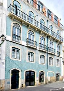 a blue brick building with windows and balconies at INT Lisbon Suites in Lisbon