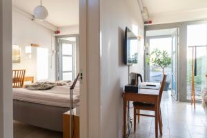 a bedroom with a bed and a desk with a computer at Fårösunds Fästning in Fårösund