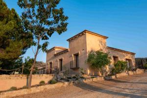 an old stone house with a fence around it at Ribazos de la Sierra in Carmona