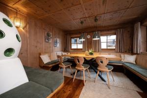 a living room with a table and chairs at Ferienhaus Valsora in Sölden