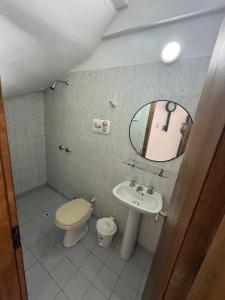 a bathroom with a toilet and a sink and a mirror at Duplex 3 con cochera privada y parrilla in San Clemente del Tuyú +30 photos
