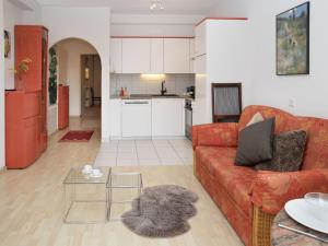 a living room with a red couch and a table at Apartment Alpes et Lac 28 by Interhome in Champex