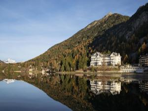 a house on a lake in front of a mountain at Apartment Alpes et Lac 28 by Interhome in Champex