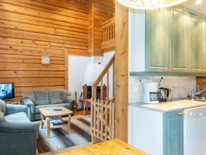 a kitchen and living room in a log cabin at Holiday Home Kranni 1 by Interhome in Syöte