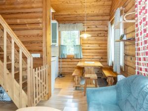 a dining room with a table in a log cabin at Holiday Home Kranni 1 by Interhome in Syöte