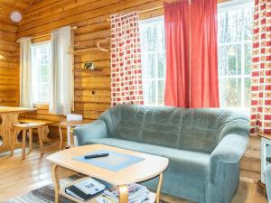 a living room with a couch and a table at Holiday Home Kranni 1 by Interhome in Syöte +12 photos