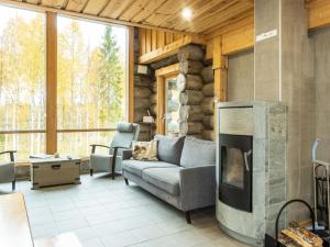 a living room with a couch and a fireplace at Holiday Home Kojamopirtit by Interhome in Kolari +27 photos