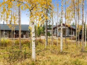 a log cabin in the woods with trees at Holiday Home Kojamopirtit by Interhome in Kolari