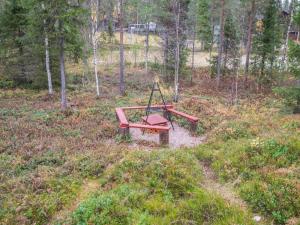 a park bench sitting in the middle of a field at Holiday Home Isokuru 3 by Interhome in Pyhätunturi