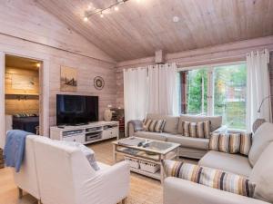 a living room with a couch and a tv at Holiday Home Isokuru 3 by Interhome in Pyhätunturi